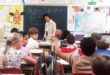 woman standing in front of children